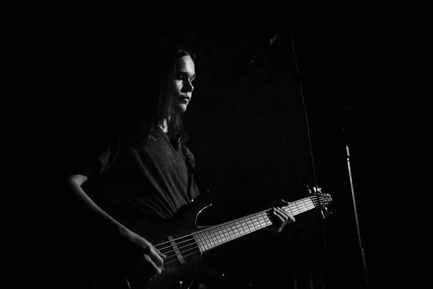 Vocalist performing under red stage lights
