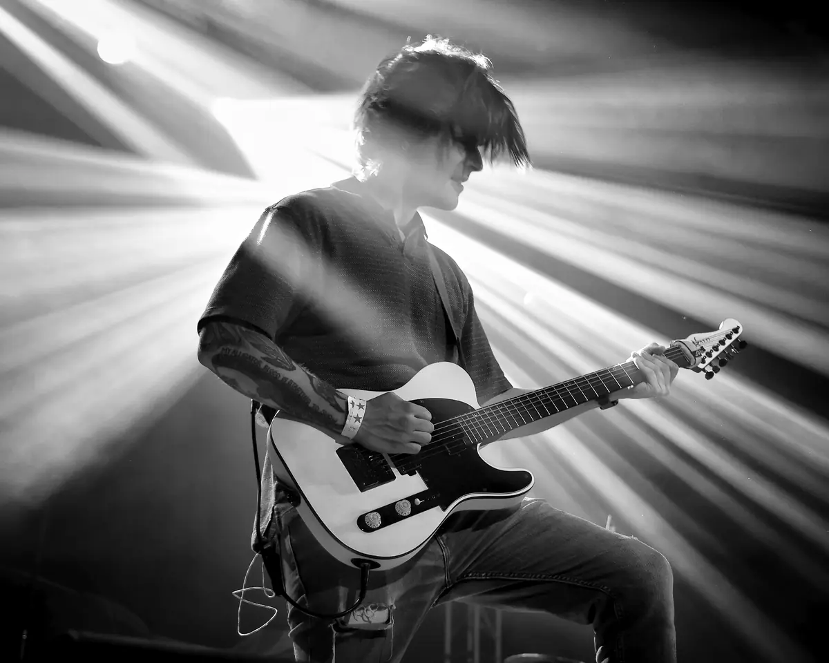 Guitarist in purple stage light and haze